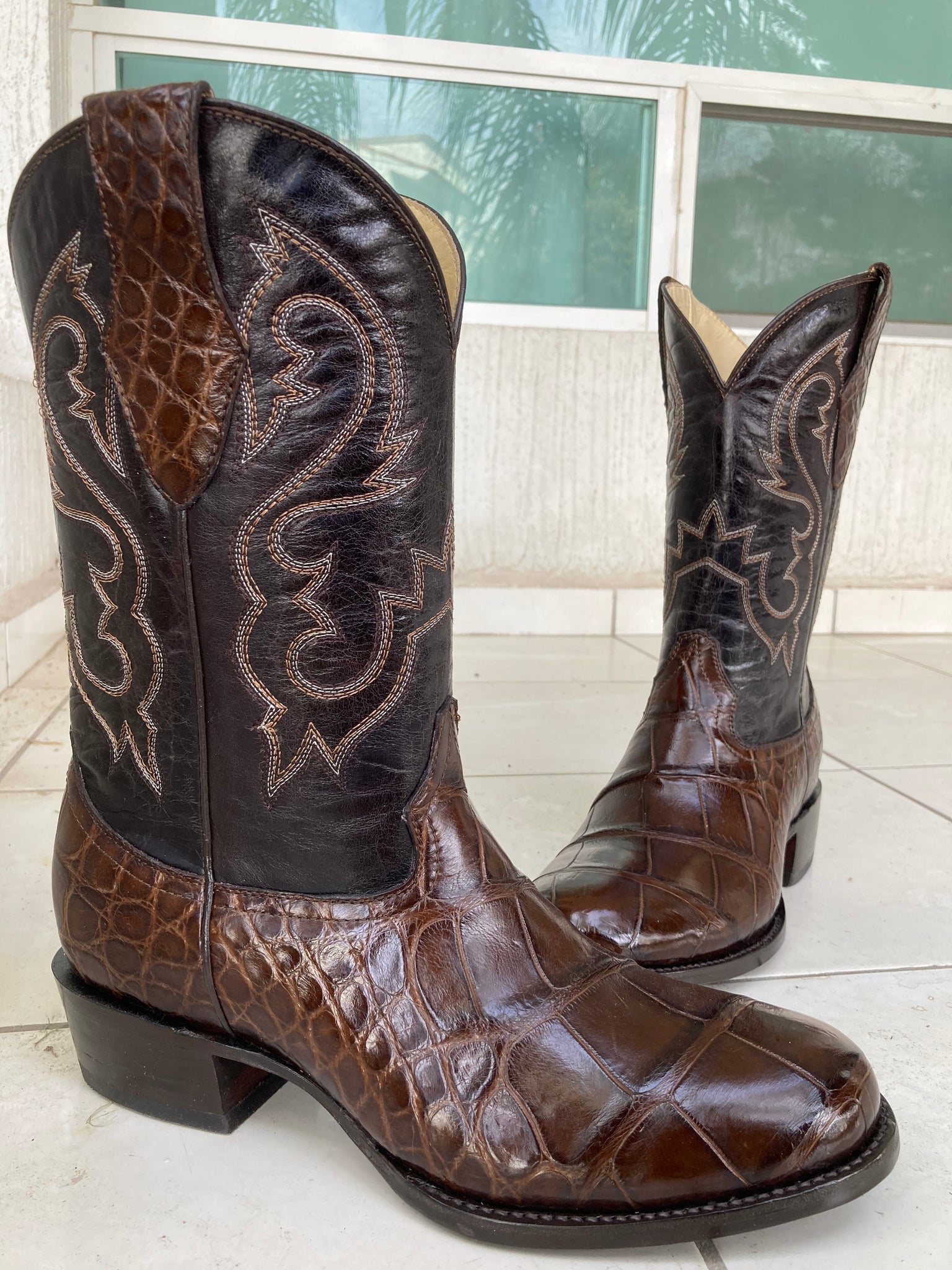 A pair of chocolate brown American alligator custom boots made using a customers own hide 