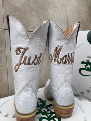 A custom made pair of white cowboy botos made for a wedding using white lizard skin with custom embroidery