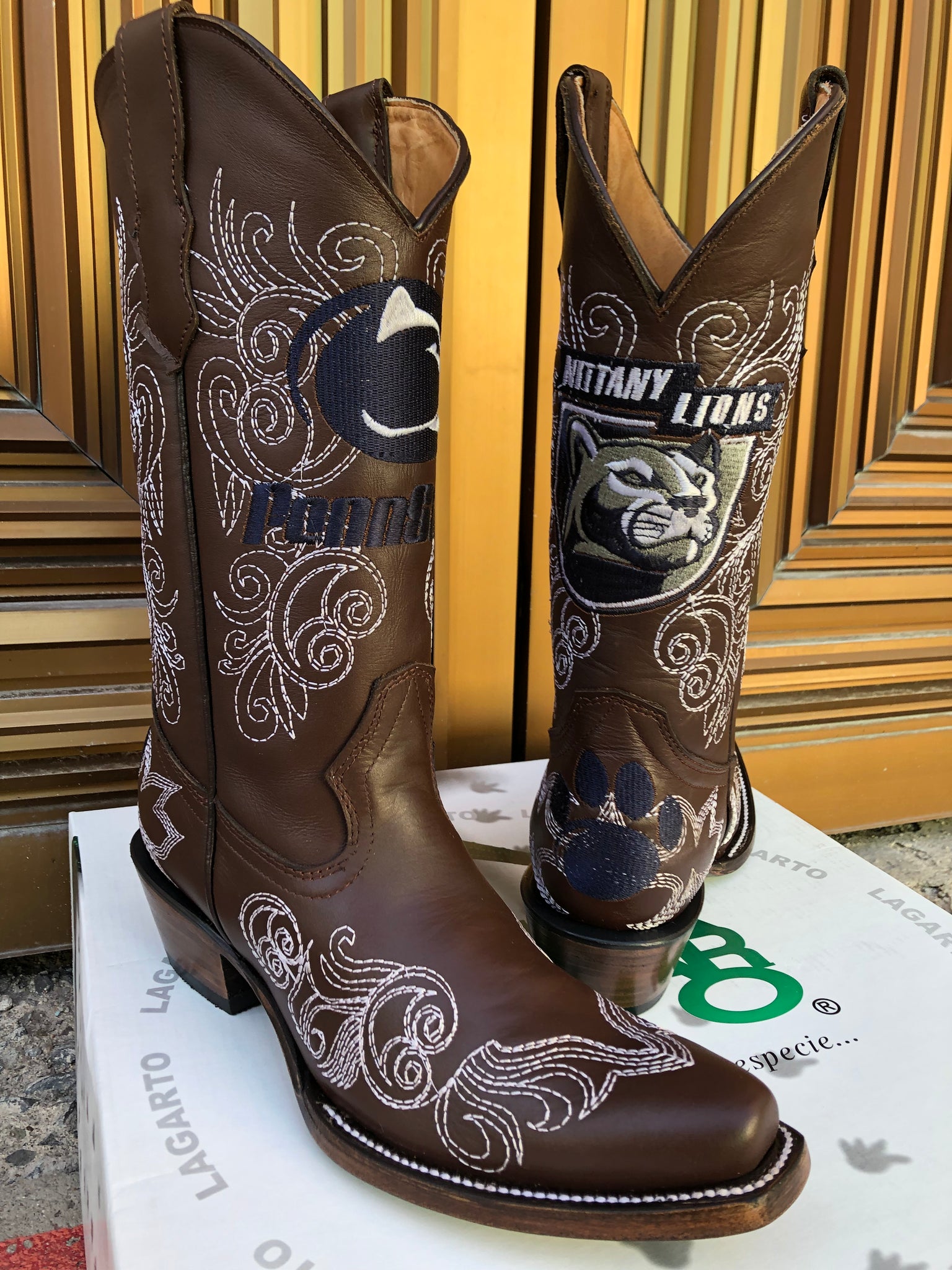 Brown cowboy boots with the Pennsylvania State University logos custom stitched on 