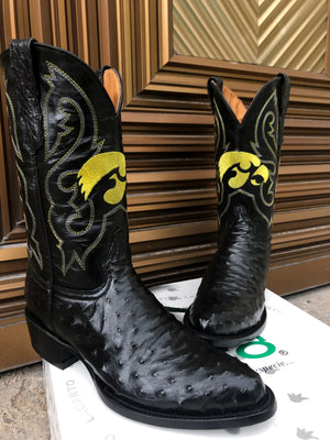 A pair of round toe black ostrich cowboy boots with the University of Iowa Herky the Hawk logo stitched on